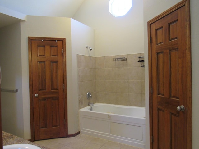 bathroom featuring tile patterned flooring and  shower combination