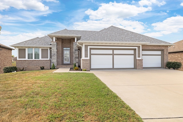 prairie-style house with a front lawn and a garage