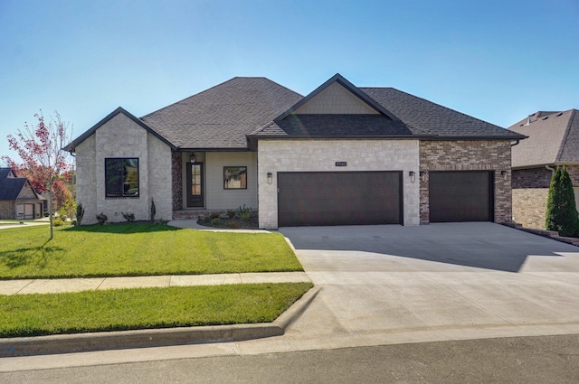 view of front of property featuring a garage and a front lawn