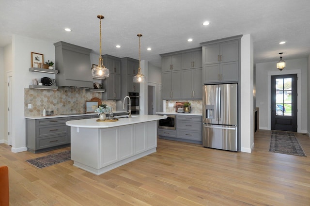 3940 E Ridgeview St, Springfield, MO 65809 - kitchen featuring appliances with stainless steel finishes, gray cabinets, open shelves, light countertops, and backsplash