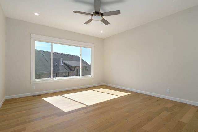 spare room with light hardwood / wood-style floors and ceiling fan