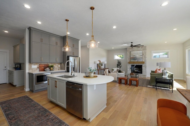 3940 E Ridgeview St, Springfield, MO 65809 - kitchen featuring gray cabinetry, stainless steel appliances, light countertops, open floor plan, and recessed lighting