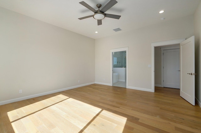 unfurnished bedroom with connected bathroom, light wood-type flooring, and ceiling fan