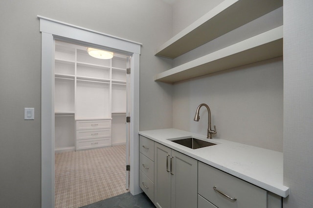 3940 E Ridgeview St, Springfield, MO 65809 - laundry area featuring a sink and dark carpet