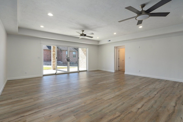 3940 E Ridgeview St, Springfield, MO 65809 - empty room with wood finished floors, ceiling fan, recessed lighting, a textured ceiling, and french doors