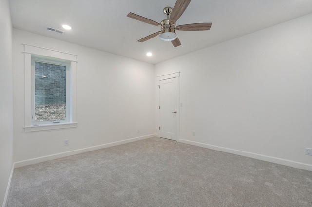 unfurnished room with ceiling fan and light colored carpet