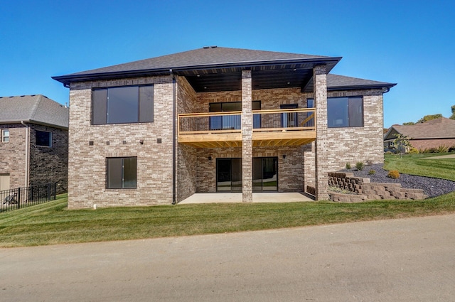 back of house featuring a patio area, a lawn, and a balcony