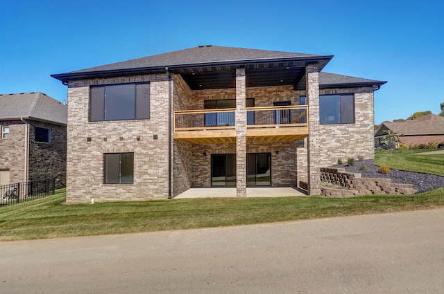 3940 E Ridgeview St, Springfield, MO 65809 - back of property featuring a balcony, brick siding, a patio, and a lawn