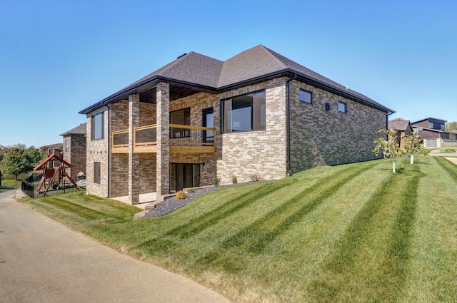 3940 E Ridgeview St, Springfield, MO 65809 - view of side of property featuring a balcony, brick siding, and a yard