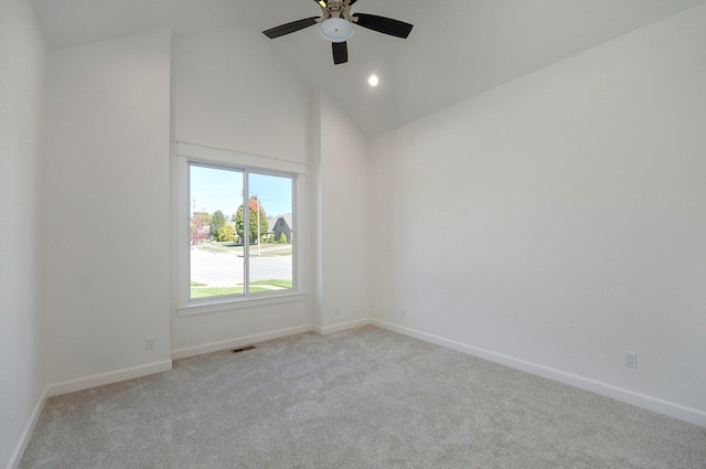 carpeted empty room with high vaulted ceiling and ceiling fan