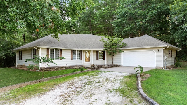 ranch-style home featuring a garage and a front yard