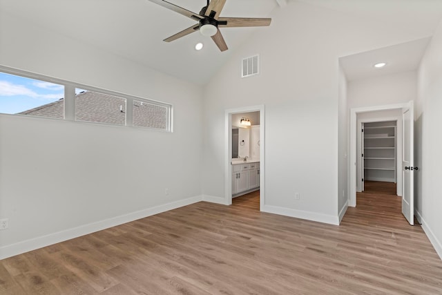 unfurnished bedroom featuring ensuite bathroom, ceiling fan, and light hardwood / wood-style floors