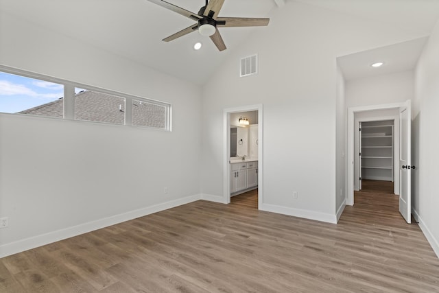 unfurnished bedroom with light wood-type flooring, baseboards, visible vents, recessed lighting, and high vaulted ceiling