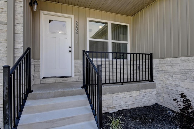doorway to property featuring board and batten siding