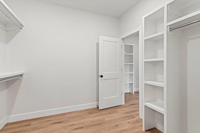 spacious closet featuring hardwood / wood-style flooring