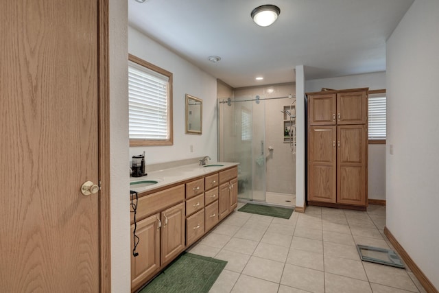 bathroom with tile patterned floors, vanity, and a shower with shower door