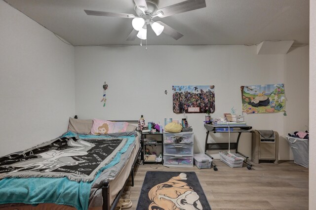 bedroom with ceiling fan and light wood-type flooring