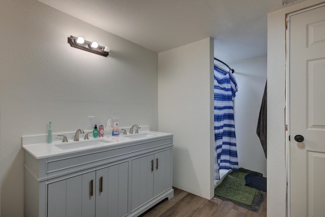 bathroom featuring hardwood / wood-style floors, vanity, and a shower with curtain