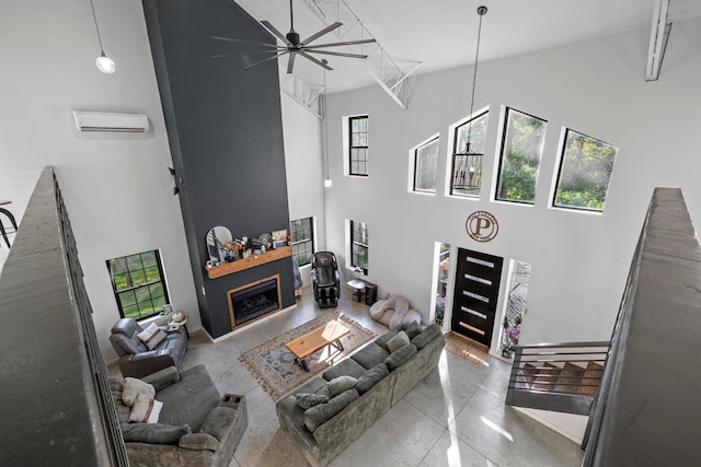 living room with a high ceiling and ceiling fan