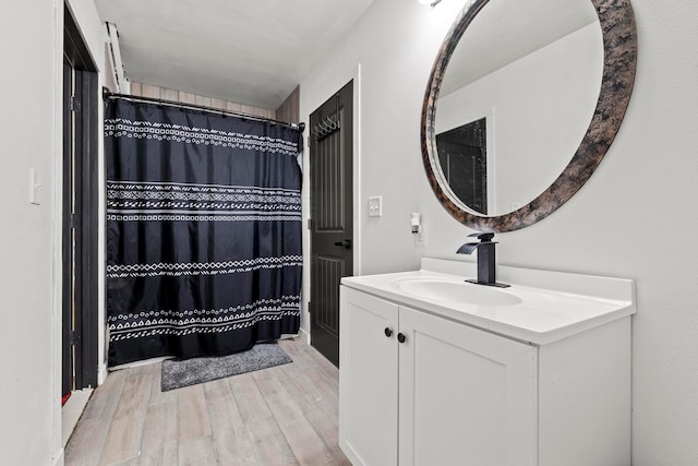 bathroom featuring wood-type flooring, vanity, and a shower with curtain