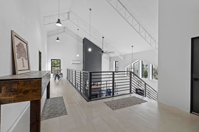 hallway with a high ceiling and a wealth of natural light