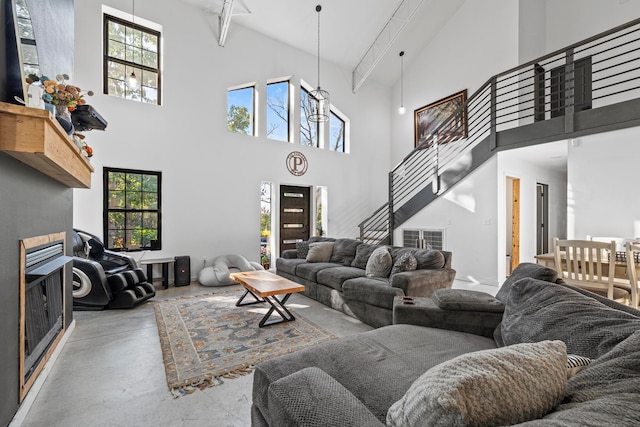 living room featuring high vaulted ceiling, a wealth of natural light, and beamed ceiling