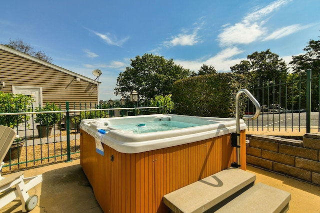 view of swimming pool featuring a hot tub