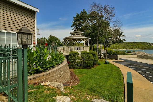 view of yard featuring a gazebo and a water view