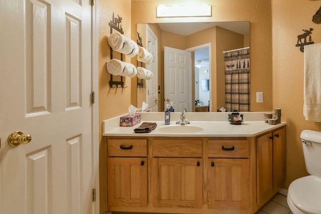 bathroom with vanity, toilet, and tile patterned floors