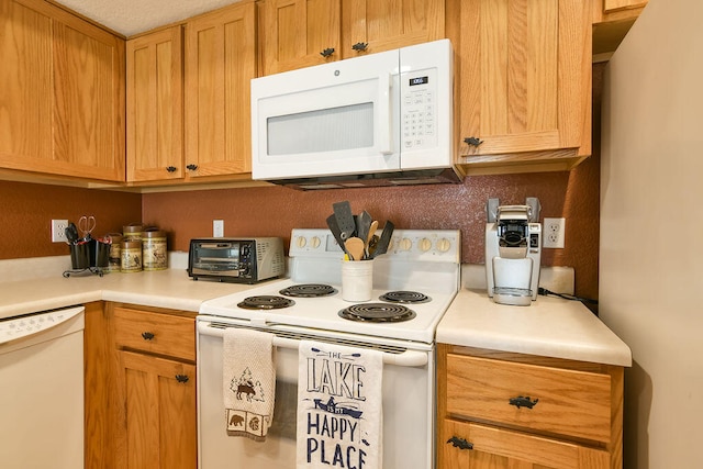 kitchen with white appliances and a textured ceiling