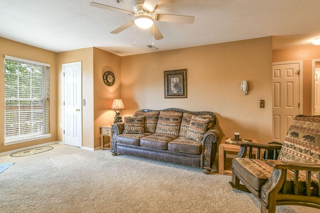 living room with light colored carpet, a textured ceiling, and ceiling fan