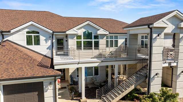 rear view of property featuring a garage