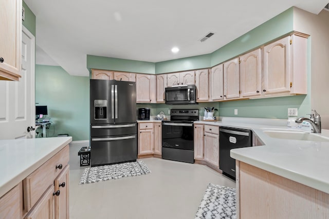 kitchen with light brown cabinetry, sink, and black appliances