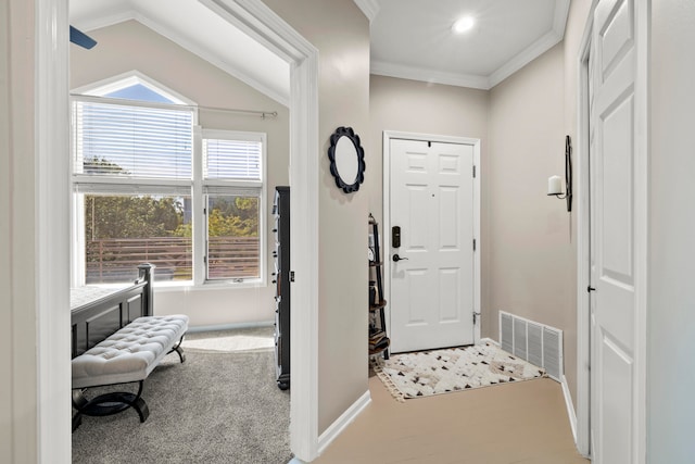 carpeted entryway featuring lofted ceiling, plenty of natural light, and ornamental molding