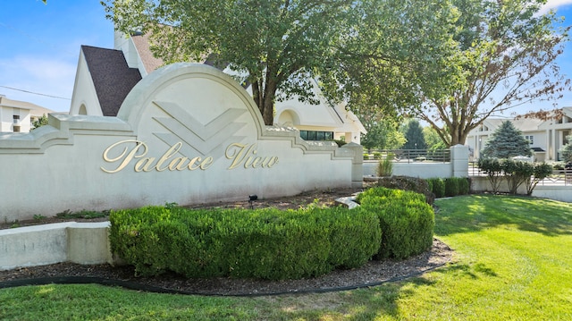 community / neighborhood sign with a lawn