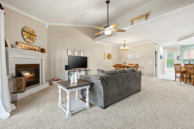 living room with ornamental molding, ceiling fan, carpet floors, and a tile fireplace