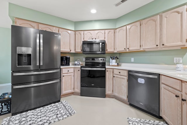 kitchen featuring light brown cabinetry and black appliances