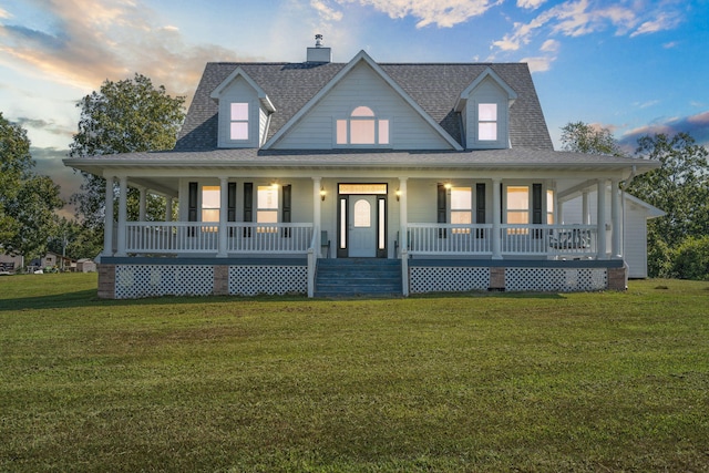 farmhouse featuring a porch and a yard