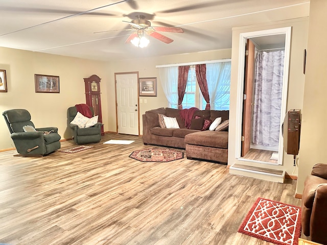 living room with ceiling fan and light hardwood / wood-style floors