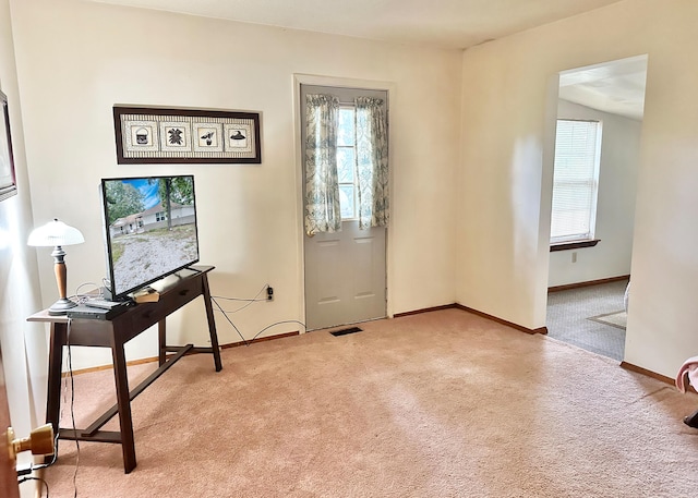 doorway to outside with carpet floors