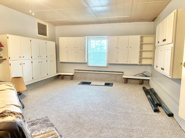 interior space with light carpet and a baseboard heating unit