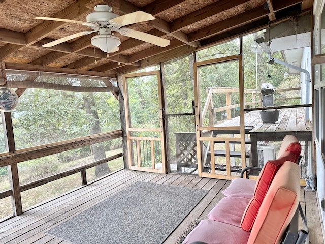 sunroom featuring lofted ceiling and ceiling fan