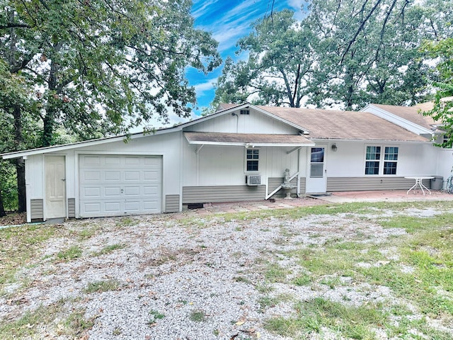 view of front of home featuring a garage and cooling unit