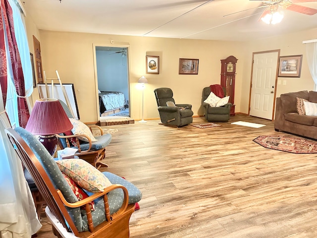 living room featuring light wood-type flooring and ceiling fan