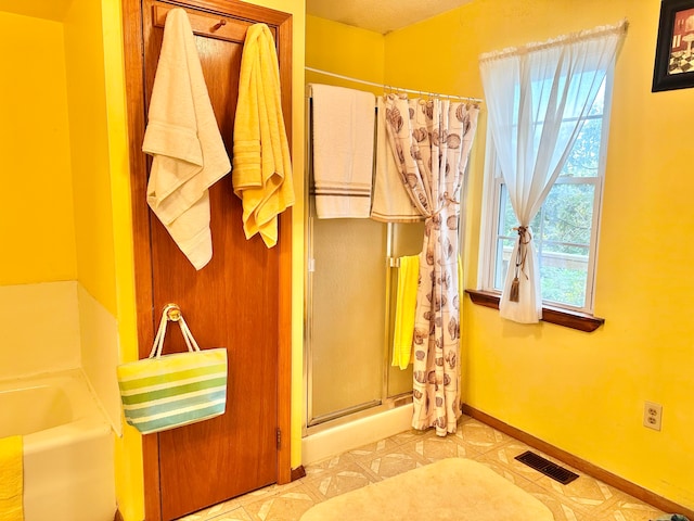 bathroom featuring tile patterned flooring and plus walk in shower