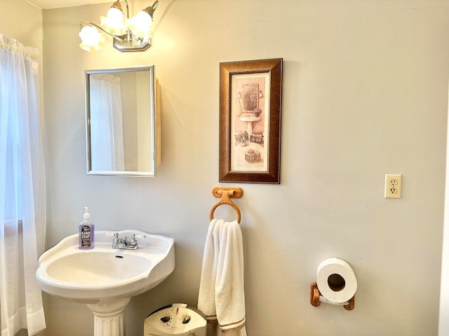 bathroom with a notable chandelier and sink