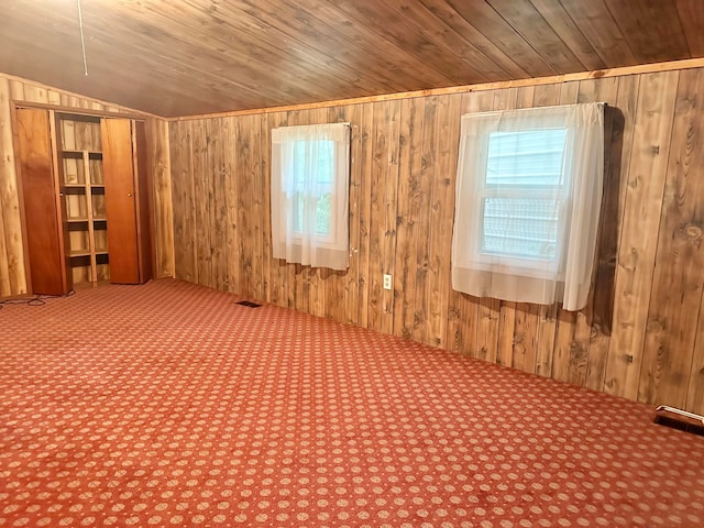 spare room with lofted ceiling, wooden walls, and wood ceiling