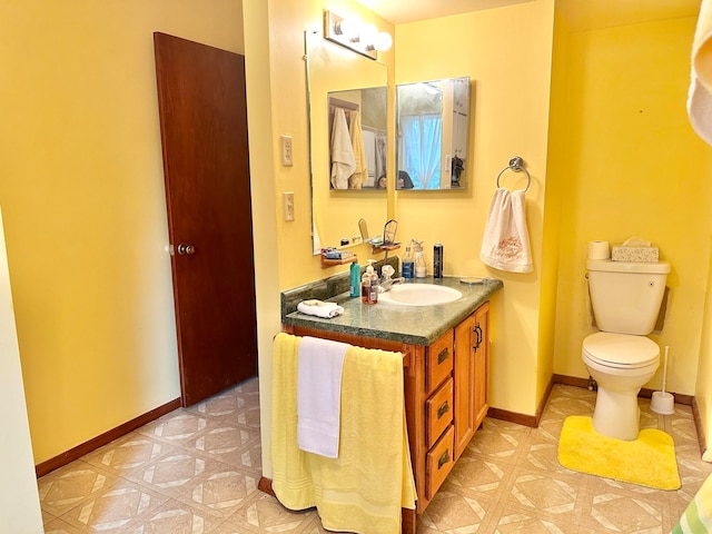 bathroom featuring toilet and vanity