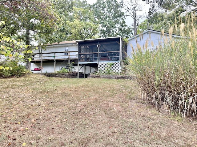 rear view of house featuring a sunroom