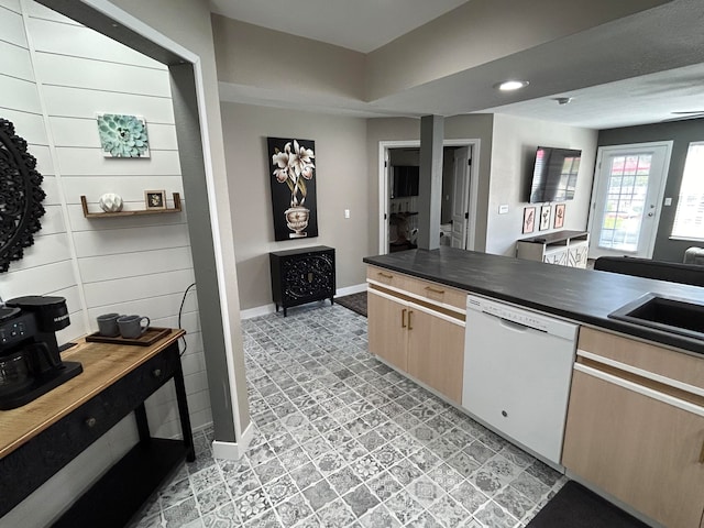 kitchen with white dishwasher, light brown cabinetry, sink, and light tile patterned flooring